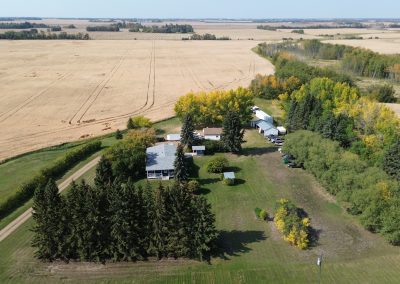 Aerial view of Northern Winds lodge in Alberta, surrounded by vast hunting territory and farmland, showcasing lush greenery and seasonal foliage in a prime waterfowl hunting area.