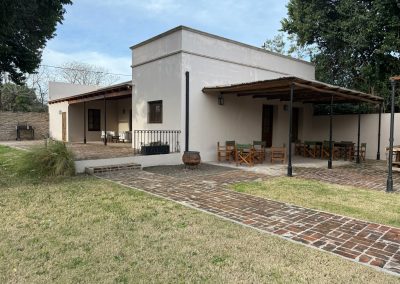 Newly constructed lodge at Las Tapias dove hunting retreat, featuring outdoor seating area, brick pathways, and surrounding greenery in Entre Ríos, Argentina.