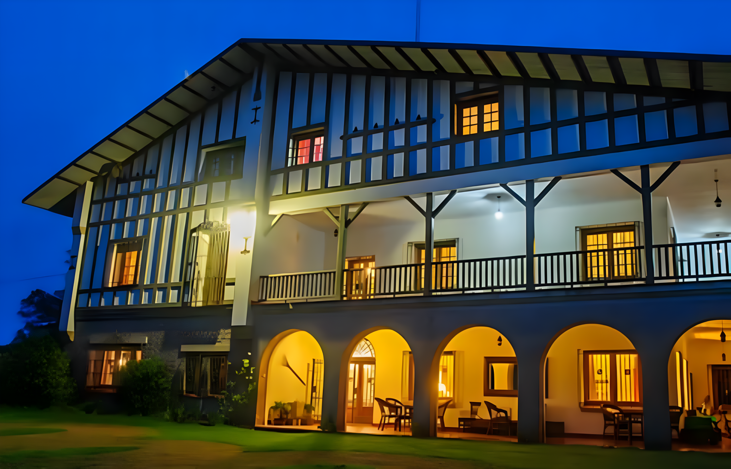 Estancia Santa Rita lodge exterior at dusk, showcasing French Basque architecture, illuminated windows, and inviting outdoor seating, highlighting luxury accommodations for duck hunting in Argentina.