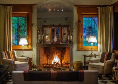 Cozy lodge interior at Estancia Santa Rita featuring a warm fireplace, elegant seating, and ambient lighting, highlighting the refined hospitality and comfort of the duck hunting experience in Argentina.