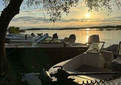 Golden Dorado fishing boats on the Paraná River at sunset, Don Joaquín River Lodge, Argentina.